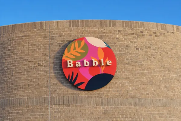 Round Babble sign on a brick wall