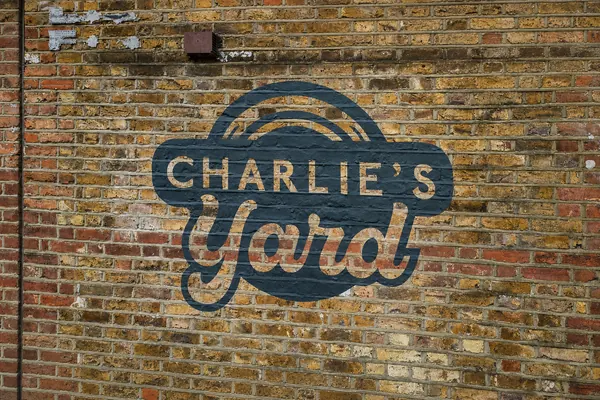 Charlie's Yard painted on a brick wall