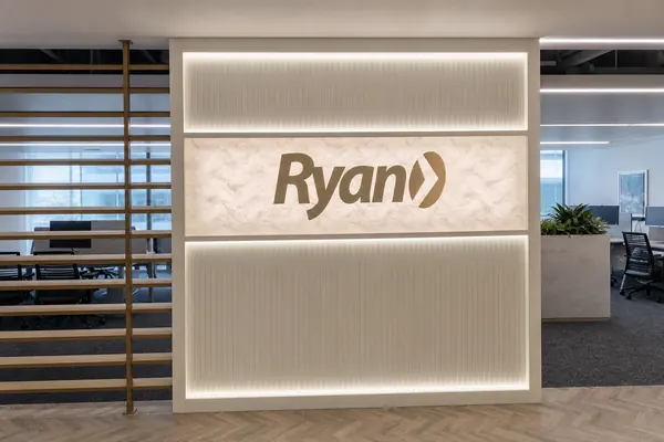 Ryan office sign on a lit reception wall